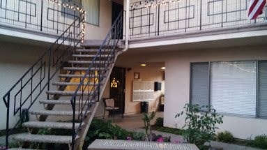 an apartment building with stairs and a balcony